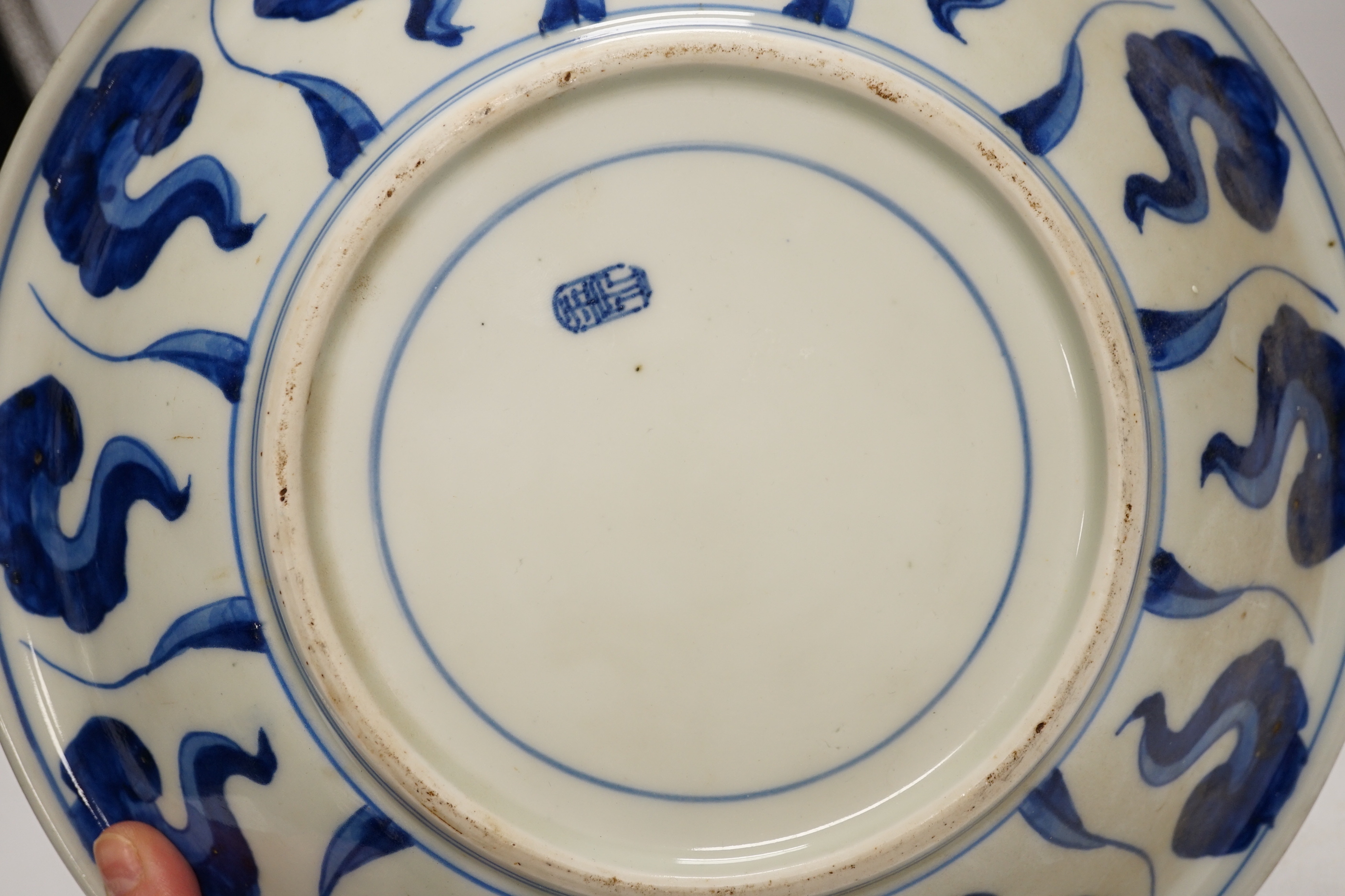 Assorted Chinese and Japanese ceramics comprising a famille rose bowl, two blue and white plates and a blue and white bowl, largest 30cm in diameter